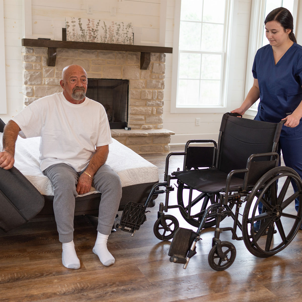 Hi-low adjustable hospital beds lowered for a wheelchair transfer